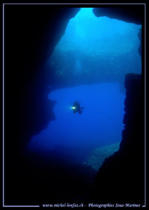 My wife Caroline entering the cave at the bottom of the B... by Michel Lonfat 